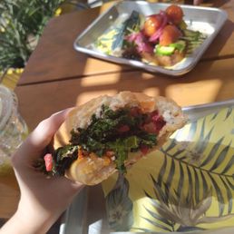 The veggie sandwich (sub goat cheese for hummus) with avocado toast in background