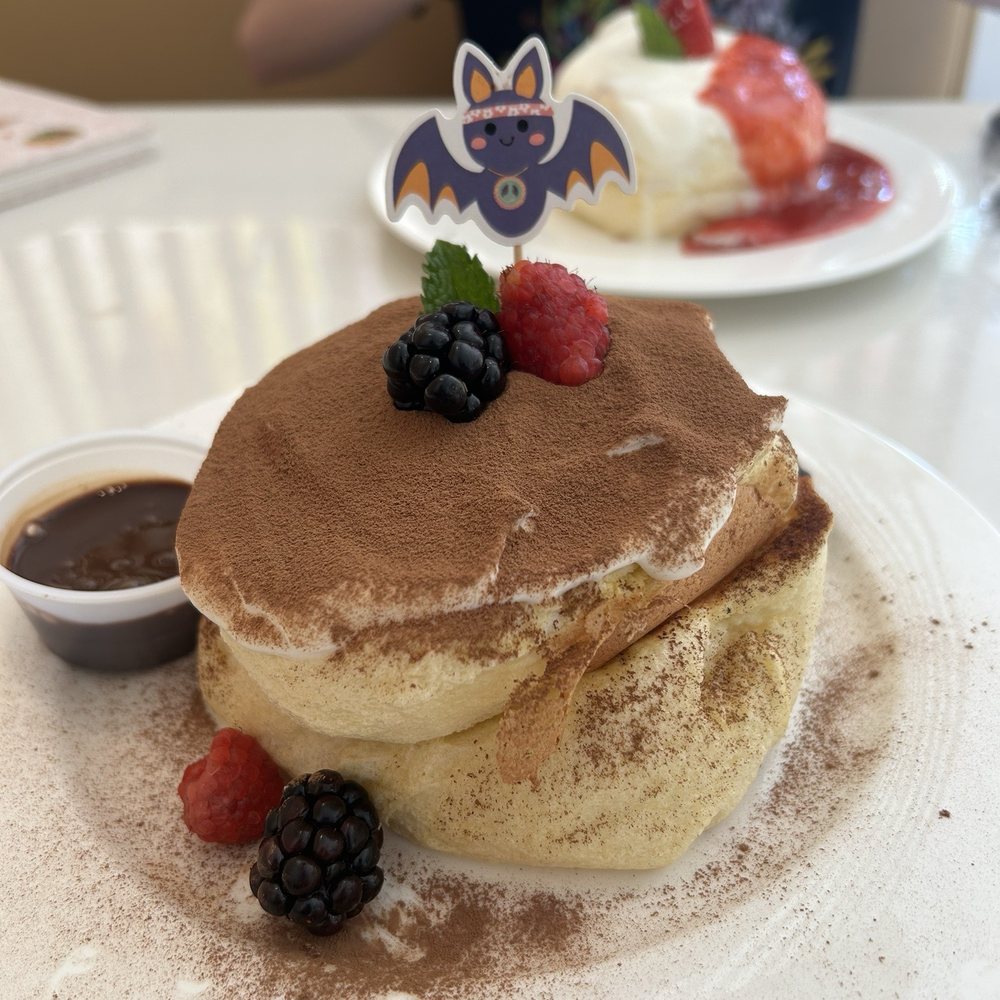 Fluffy Fluffy Dessert Cafe - Tiramisu pancake in foreground, strawberry pancake in background. - Desserts Near Me - Orlando, Florida Fluffy Fluffy Dessert Cafe - Tiramisu pancake in foreground, strawberry pancake in background. - Desserts Near Me - Orlando, Florida