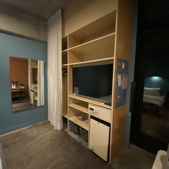 The Carpenter Hotel - Book shelf with TV - Hotels Near Me - Austin, Texas