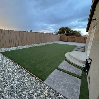 Alvo Landscape - a backyard with artificial grass and steps - Landscaping Near Me Alvo Landscape - a backyard with artificial grass and steps - Landscaping Near Me