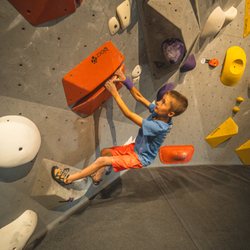 Youth climber enjoying the adventure and problem solving that bouldering provides.