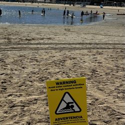 Mother's Beach - Posted High Bacteria Water Content Advising Against Water Activities with people in the water ignoring or numb to the warning.
