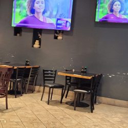 Zushingazo Sushi On Main Street - Tables and chairs are varied and unmatching. Walls have dinged paint.