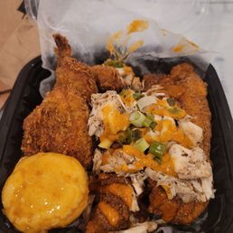 Fried catfish topped with crab, corn muffin and wings