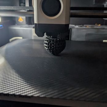 Howarth Tech Solutions - A golf ball coming off the bed after a 3D printer tune up. We service and repair 3D printers for everyone across greater Denver. - IT Services & Computer Repair Near Me - Aurora, Colorado Howarth Tech Solutions - A golf ball coming off the bed after a 3D printer tune up. We service and repair 3D printers for everyone across greater Denver. - IT Services & Computer Repair Near Me - Aurora, Colorado