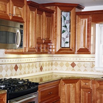 Absolute Home Remodeling - a kitchen with wood cabinets - General Contractors Near Me - Pompano Beach, Florida Absolute Home Remodeling - a kitchen with wood cabinets - General Contractors Near Me - Pompano Beach, Florida