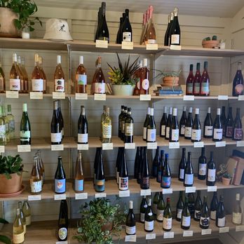 Cork & Screw - a shelf full of wine bottles - Beer, Wine & Spirits Near Me - Austin, Texas
