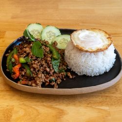 Krapow pork with runny egg on top of rice
