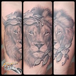 Crown Tattoos - Realistic lion combined with neo traditional style leaves