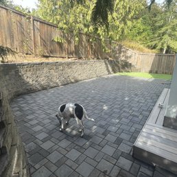 Retaining wall, paver patio, and turf.