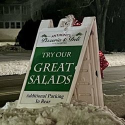 Anthony's Pizzeria & Deli - Street sign - a few parking spots out front, more out back