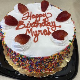 a birthday cake with strawberries and sprinkles a birthday cake with strawberries and sprinkles