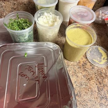 Los Jefes Grill Harahan - All the fixings for taco bar catering. Salsa verde, cilantro, onion, agreed cheese, sour cream, limes and pan of corn tortillas - Mexican Near Me - Harahan, Louisiana Los Jefes Grill Harahan - All the fixings for taco bar catering. Salsa verde, cilantro, onion, agreed cheese, sour cream, limes and pan of corn tortillas - Mexican Near Me - Harahan, Louisiana