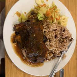 Jerk chicken with side of rice and peas and cabbage