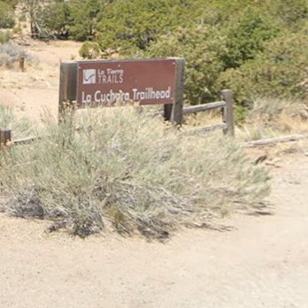 La Tierra Hiking Trail - Sign behind the church marking the road toward the La Cuchara trailhead parking area - Hiking Near Me - Santa Fe, New Mexico