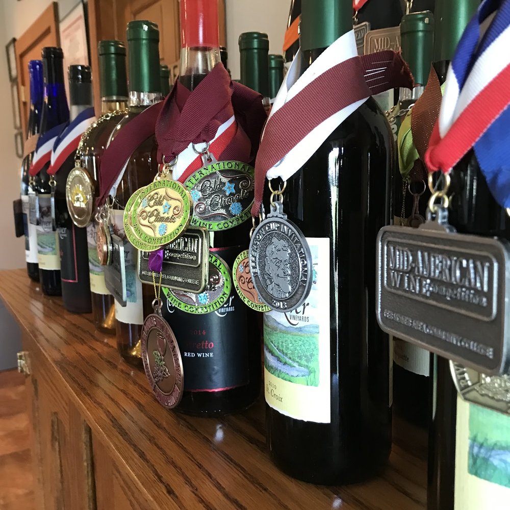 Feather River Winery - a row of wine bottles with medals on them - Wineries Near Me - North Platte, Nebraska