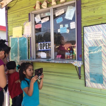 Snowball Adventure - a woman taking a picture of a child - Ice Cream & Frozen Yogurt Near Me - El Campo, Texas Snowball Adventure - a woman taking a picture of a child - Ice Cream & Frozen Yogurt Near Me - El Campo, Texas