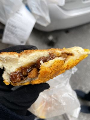 Photo of Mei Lai Wah Bakery - New York, NY, US. Pineapple Bun with Roast Pork (half-eaten)