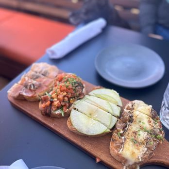 Postino Addison - Bruschetta board. Left to right prosciutto&fig, tomato buratta, apple&fig, French onion - Wine Bars Near Me - Dallas, Texas