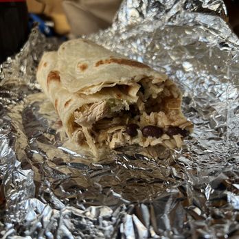 Rodeo Mexican Kitchen - a burrito wrapped in aluminum foil - Mexican Near Me - Houghton, Michigan Rodeo Mexican Kitchen - a burrito wrapped in aluminum foil - Mexican Near Me - Houghton, Michigan