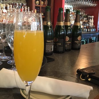 Farm Bloomington - Peach mimosa at the bar - New American Near Me - Bloomington, Indiana