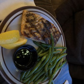 Mars Resort - Blackened salmon with nice helping of perfectly cooked green beans. - A meal featuring grilled fish, green beans, a lemon wedge, and soy sauce on a restaurant plate, with a dark wooden table background. - American Near Me - Lake Geneva, Wisconsin
