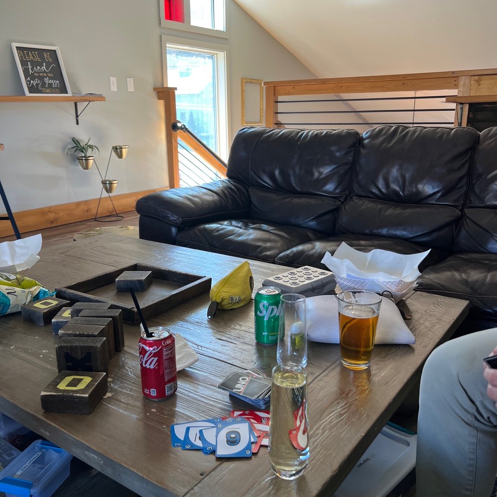 a man sitting on a couch and drinking a beer a man sitting on a couch and drinking a beer
