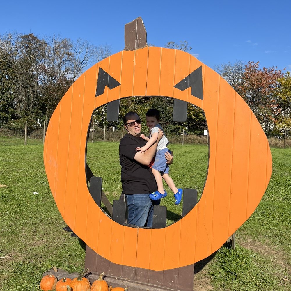 Decker Farm - a man holding a child in a pumpkin patch - Farmers Market Near Me - Staten Island, New York