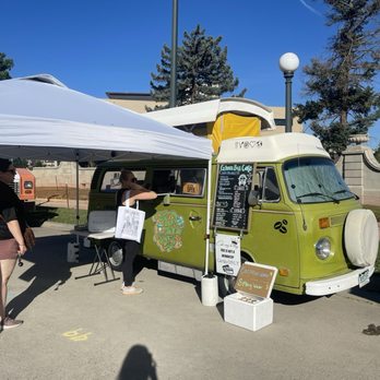 Green Bus Cafe - a woman standing in front of a green bus - Food Trucks Near Me - CO, Colorado Green Bus Cafe - a woman standing in front of a green bus - Food Trucks Near Me - CO, Colorado