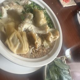 Chicken rice noodle soup with bean sprouts, won tons and Thai basil. Chicken rice noodle soup with bean sprouts, won tons and Thai basil.