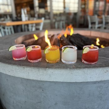 Roja Mexican Grill - a row of cocktails on a fire pit - Mexican Near Me - Omaha, Nebraska Roja Mexican Grill - a row of cocktails on a fire pit - Mexican Near Me - Omaha, Nebraska