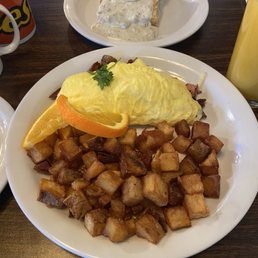 Meat lovers omelette and half order biscuits and gravy with egg on top
