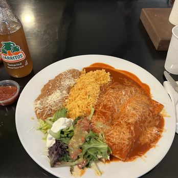 Taqueria Maya - Plate of 2 chicken enchiladas with red sauce. Sides of refried beans, rice, and salad. - Mexican Near Me - Sacramento, California Taqueria Maya - Plate of 2 chicken enchiladas with red sauce. Sides of refried beans, rice, and salad. - Mexican Near Me - Sacramento, California