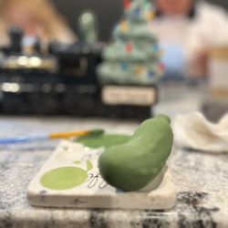 Square Seven Coffee House - Black Friday ceramic painting with the family. This is the foundation of a Christmas Pickle.