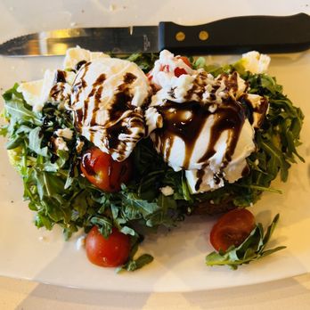Broken Yolk Cafe - Feta Avocado Toast with two poached eggs. - Breakfast & Brunch Near Me - Santee, California Broken Yolk Cafe - Feta Avocado Toast with two poached eggs. - Breakfast & Brunch Near Me - Santee, California