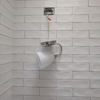 MariStav - unable to hang new light fixture because it wasn't cut out - Tiling Near Me