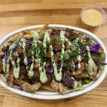 Habibi & Spice - 50/50 Bowl with a mix of chicken & Gyro. Crispy fries & delicious sauce. - Middle Eastern Near Me - Lewisville, Texas