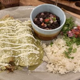 Birria enchiladas with jalapeño cream sauce. Lots of meat, moderate spicy. Cilantro lime rice.