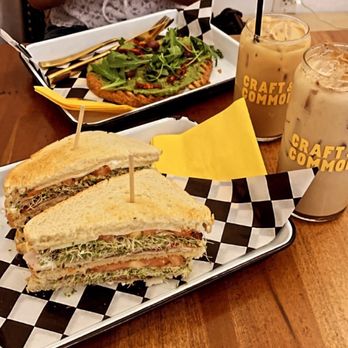 Craft & Common - Cali Club  Three layer toasted sourdough + smoked turkey + provolone cheese + bacon + sprouts + tomato + mayo  Avocado toast - Coffee & Tea Near Me - Oviedo, Florida