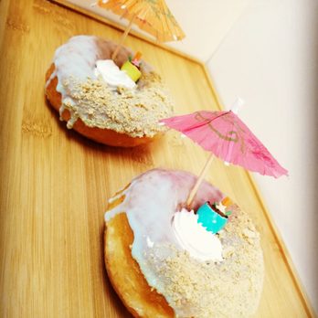 John's Donuts - two donuts covered in frosting and decorated with umbrellas - Donuts Near Me - Frisco, Texas John's Donuts - two donuts covered in frosting and decorated with umbrellas - Donuts Near Me - Frisco, Texas