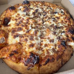 Wood oven 12" Sausage pizza $25. Sauce is tasty. A bit burned this time.