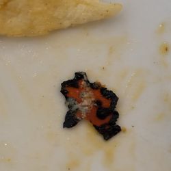 Chala's Wood Fire Grill - Found this inside my burrito!! Not food. Halloween was yesterday...is it a melted Halloween thing?!!