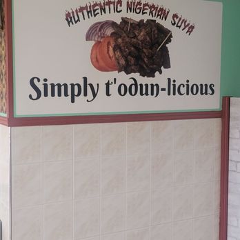 Chicken Todun - Inside sign - A sign features an image of Nigerian suya, a spicy grilled meat dish, with text that reads "Authentic Nigerian Suya" and "Simply t'odun-licious." - African Near Me - Lanham, Maryland