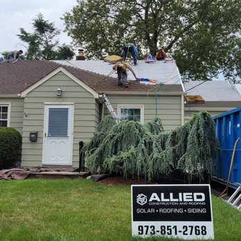 Allied Roofing & Construction - a man on the roof of a house - General Contractors Near Me - Lodi, New Jersey