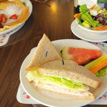 Paula's Pancake House - Danish Pancakes with berries on top left, and Turkey & Swiss with Side Salad. - Breakfast & Brunch Near Me - Solvang, California Paula's Pancake House - Danish Pancakes with berries on top left, and Turkey & Swiss with Side Salad. - Breakfast & Brunch Near Me - Solvang, California