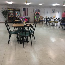 a restaurant with tables and chairs a restaurant with tables and chairs
