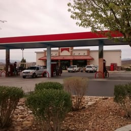 a gas station with cars parked in front of it
