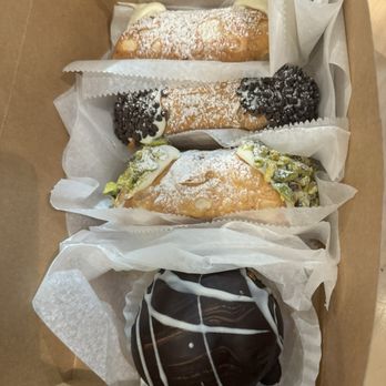 Mike’s Pastry - Variety of cannolis and a Boston cream puff - Bakeries Near Me - Boston, Massachusetts