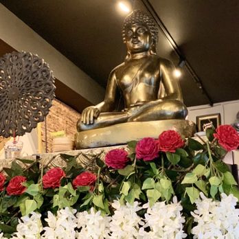 Sang Tong Thai - Kennett Square - a buddha statue surrounded by flowers - Thai Near Me - Kennett Square, Pennsylvania Sang Tong Thai - Kennett Square - a buddha statue surrounded by flowers - Thai Near Me - Kennett Square, Pennsylvania