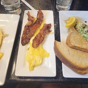 Keke's Breakfast Cafe - Banana waffle, eggs, bacon, cheesesteak omelet & grits (I forgot to get a picture of the bacon and sausage omelet) - Breakfast & Brunch Near Me - Kissimmee, Florida